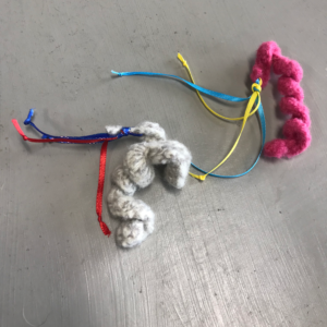 two wool felted squiggle kitty pebbles