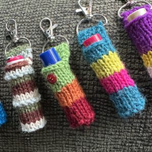 four lip balm cozies with clips in assorted colors